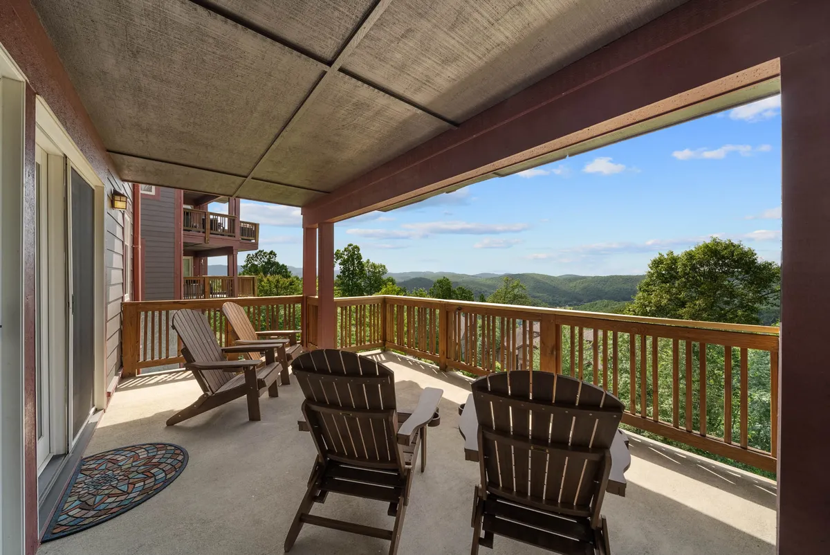 A tranquil deck scene with wooden chairs overlooking rolling mountains under an expansive sky. The peaceful setting suggests moments of gathering, reflection, and soaking in the views after a day of adventure.