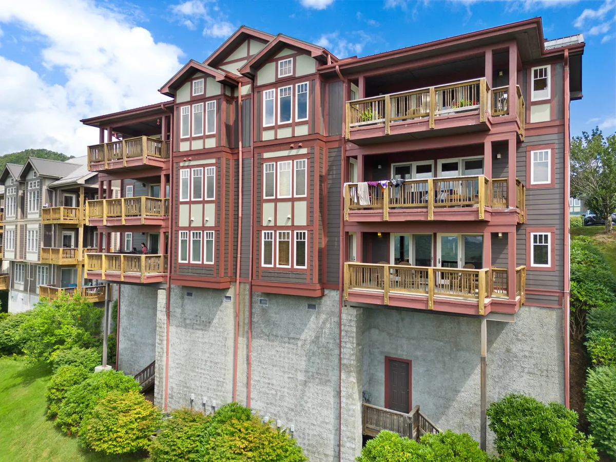 This exterior shot showcases the retreat's balconies, ample windows, and lush landscaping. The balconies are furnished for comfort, inviting guests to step outside and take in the expansive mountain vistas. The image illustrates the property's connection to its natural surroundings and offers visual cues for group relaxation or events.